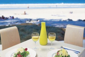 Noosa - enjoying a wine and lunch overlooking the beach - Luxury short breaks Australia