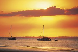 Fraser Island - boats moored at sunset on Seventy Five Mile Beach - Luxury solo tours