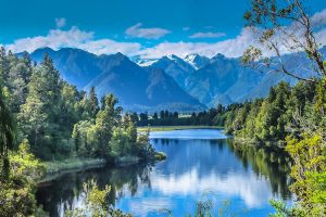 Lake Matheson - lake surrounded by native trees - Luxury short breaks New Zealand