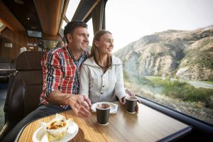 South Island - couple enjoying the view from the TranzAlpine traing - Luxury short breaks New Zealand